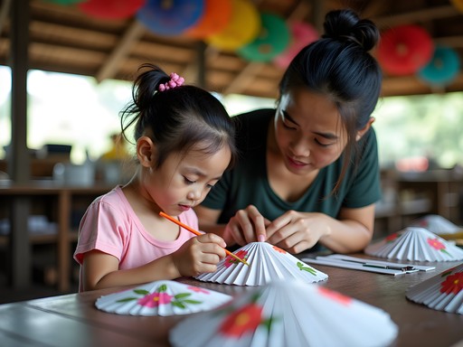 Child learning traditional umbrella painting techniques from Thai artist in Bo Sang Village
