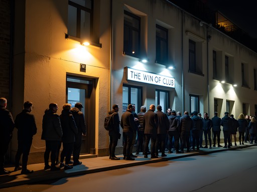 Nighttime queue outside a Berlin club with industrial facade