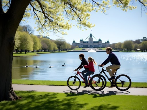 Family cycling along Lake Burley Griffin pathway with Parliament House visible in background