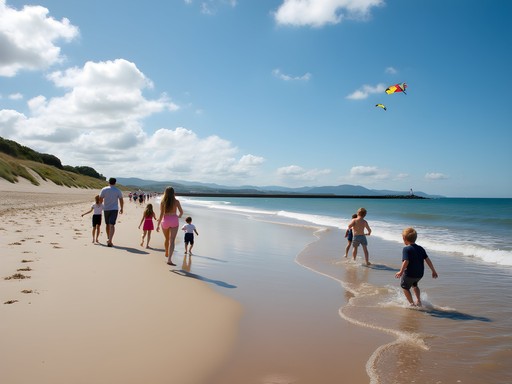 Families enjoying summer day at Dollymount Strand with Dublin Bay and Bull Wall in background