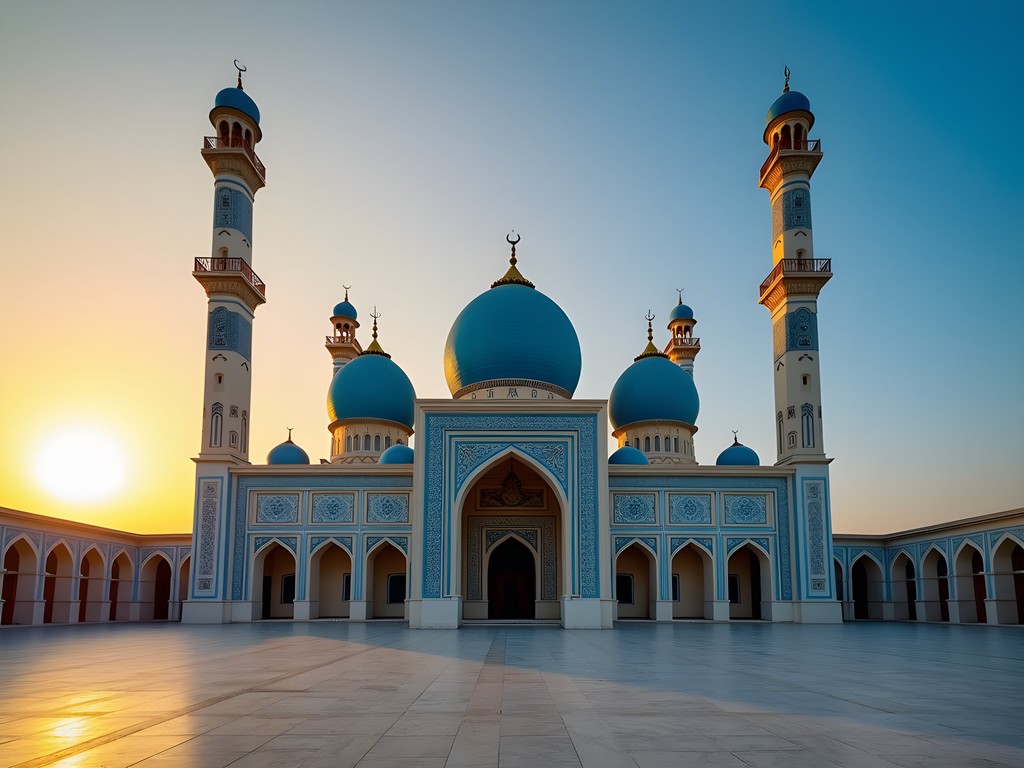Blue Mosque in Mazar-i-Sharif at sunrise with golden light illuminating the azure domes